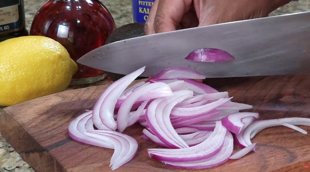 Slicing the red onion for Greek Salad
