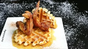 Chicken wings and waffles on a white plate