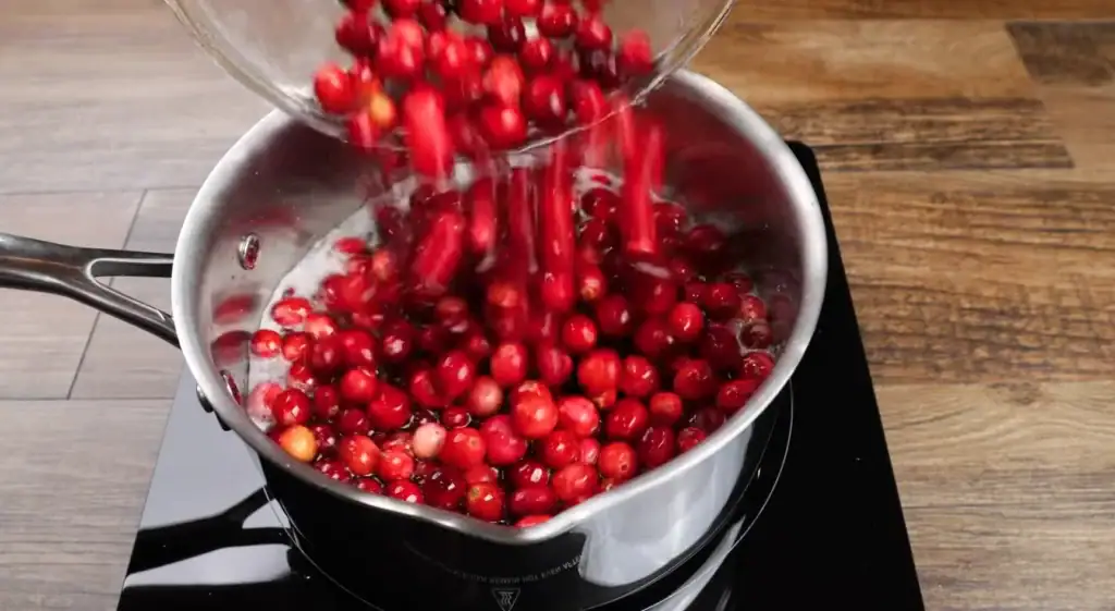 Adding the cranberries to the pot for cranberry sauce