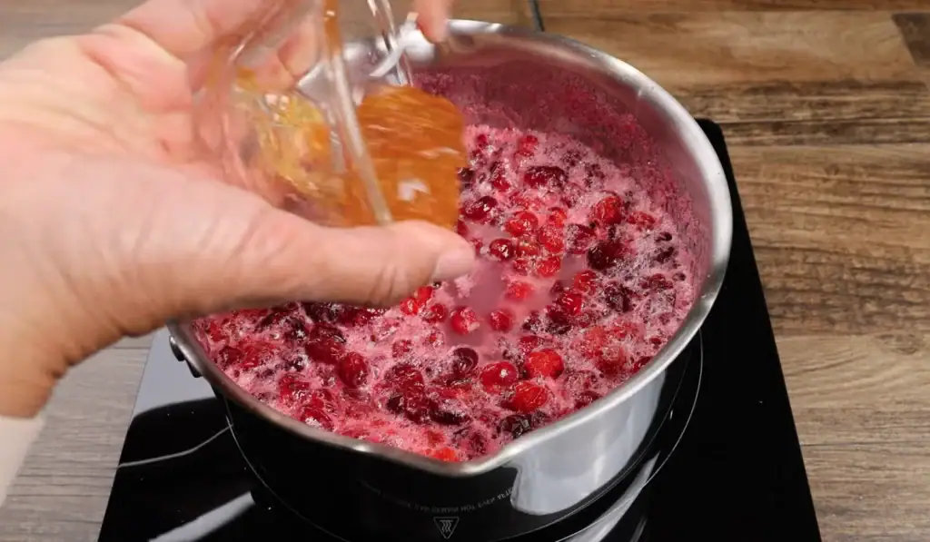 Adding the orange marmalade to the cranberry sauce