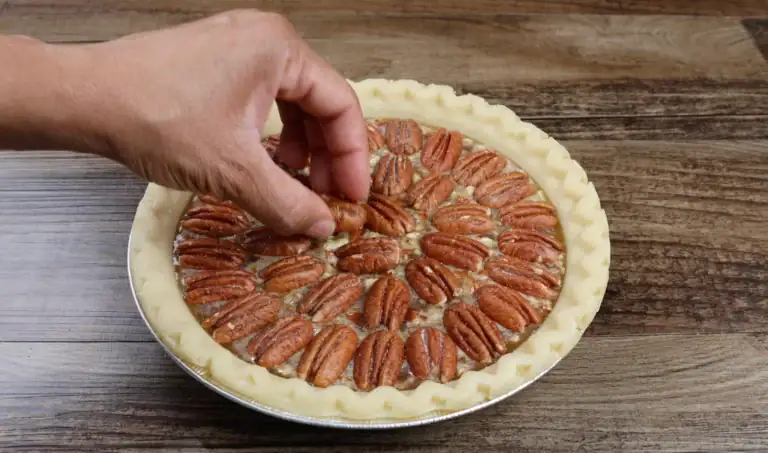 topping pecan pie with pecans