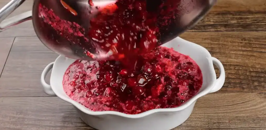 transferring cranberry sauce to dish