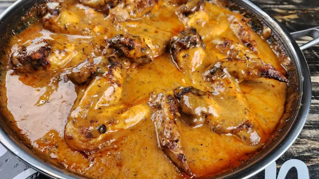 Smothered Chicken Wings in gravy in a skillet