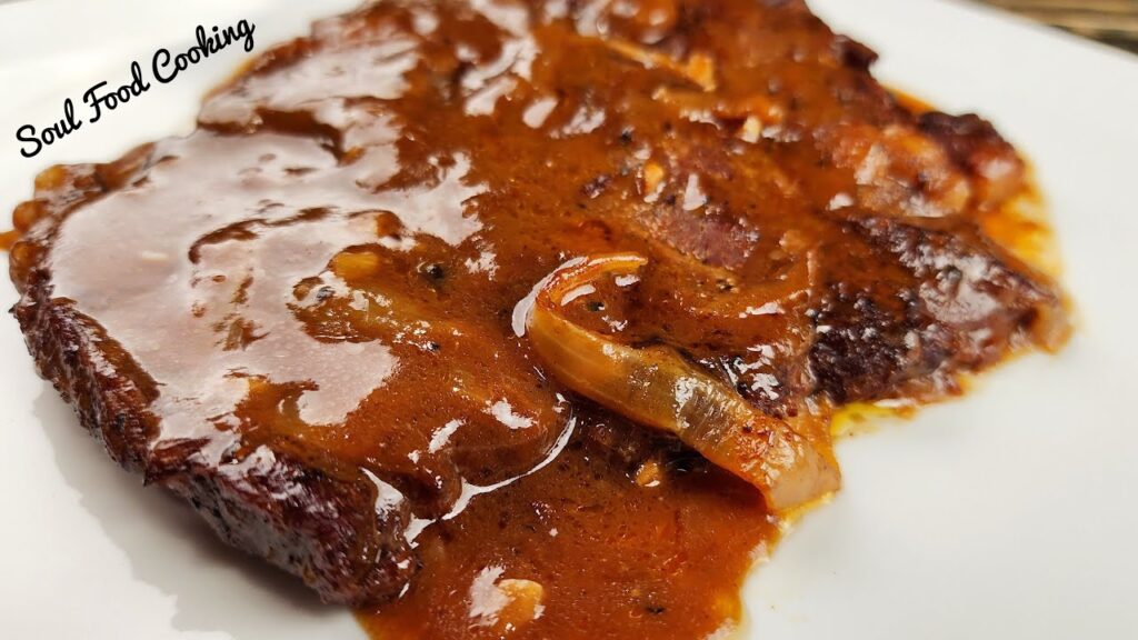 Smothered Steak and onion on a white plate