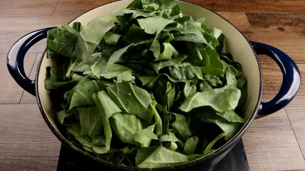 adding collard greens to pot