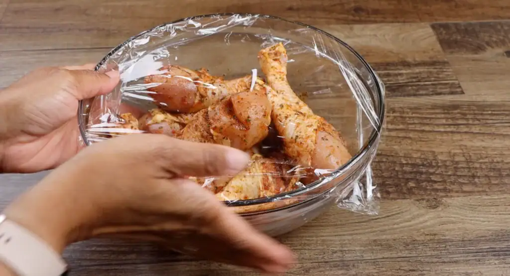 Covering Chicken with Plastic Wrap