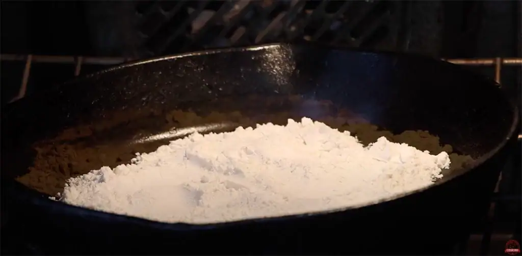 Flour roasting in the oven to create gumbo roux