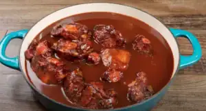 Pouring BBQ Sauce over Oxtails
