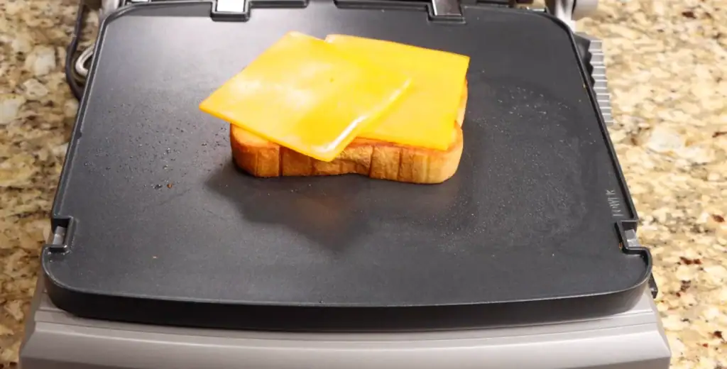 melting the cheese for the breakfast sandwich