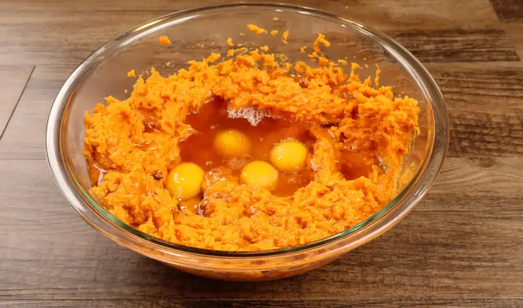 Adding the Eggs into the bowl for Brown Butter Sweet Potato Pie
