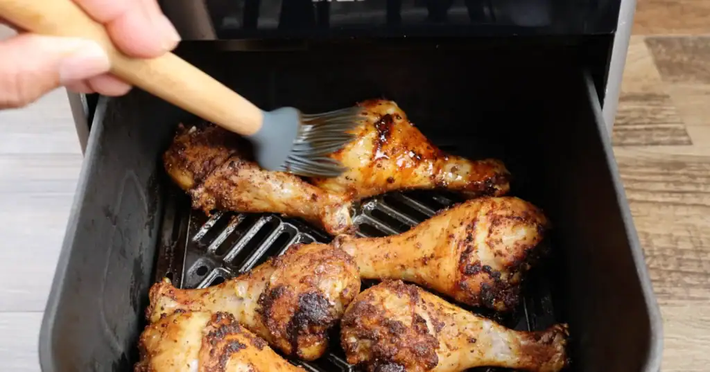 Coating the Chicken Legs with BBQ Sauce