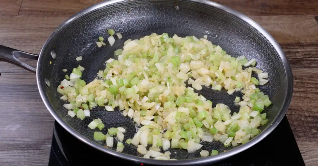 Sautéing the onion and celery for cornbread dressing