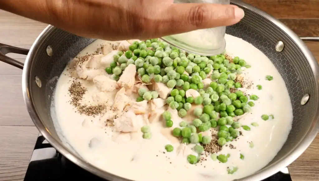 Adding the peas to Chicken a la King