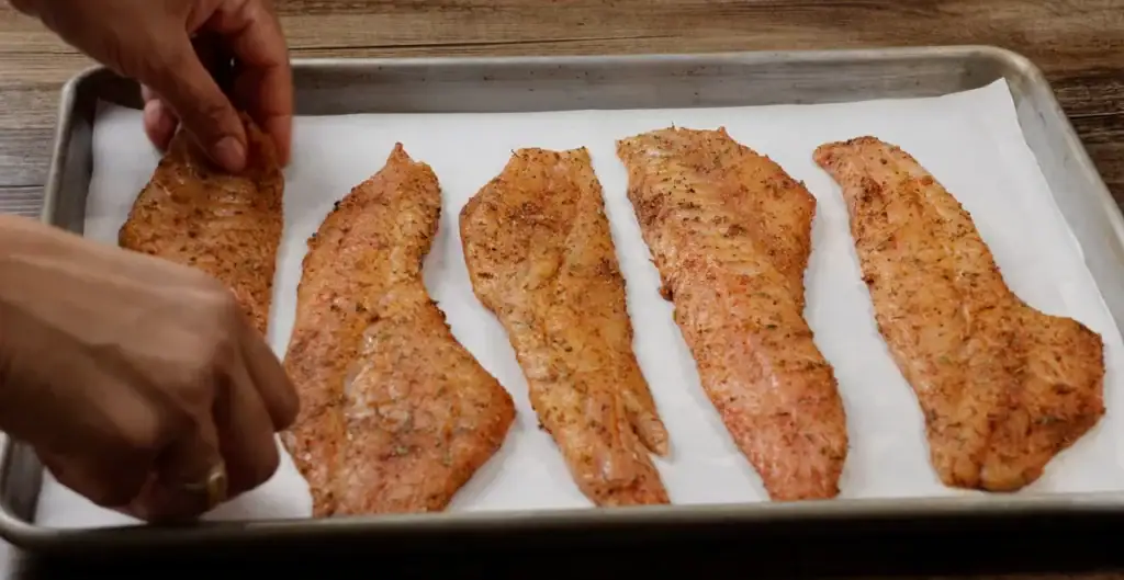 Placing the Rockfish on a baking sheet lined with parchment paper