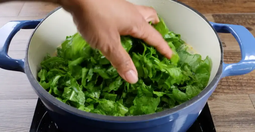 Adding Mustard Greens to Dutch Oven