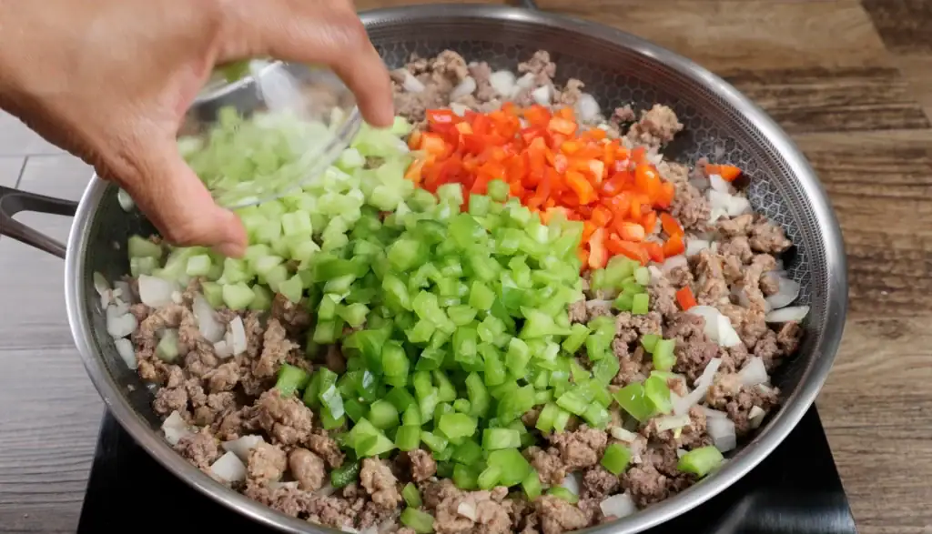 Adding the Red Bell Peppers, Green Bell Pepper and Celery