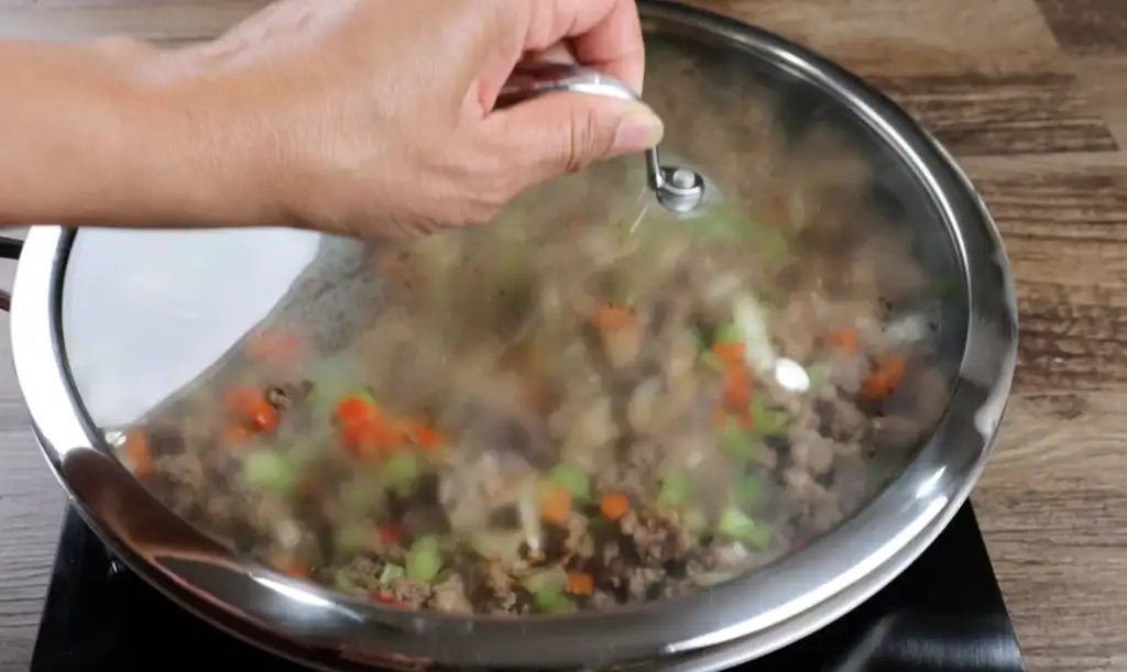 Covering the Meat for Shrimp Dirty Rice to Simmer
