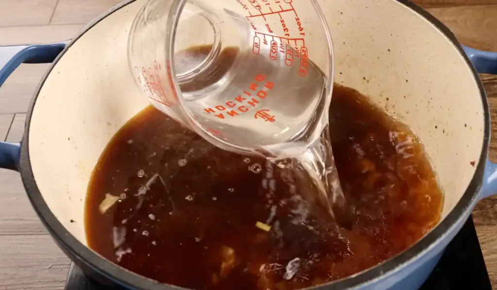 Adding the Beef Broth and Water to the Pot for Beef Neck Bones