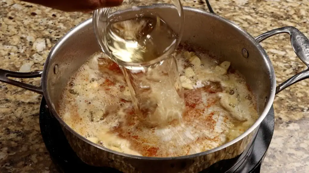 Pouring the Wine to Deglaze the Pan for Seafood Pasta
