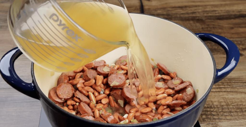 Adding the Chicken Broth to the Pot of Red Beans