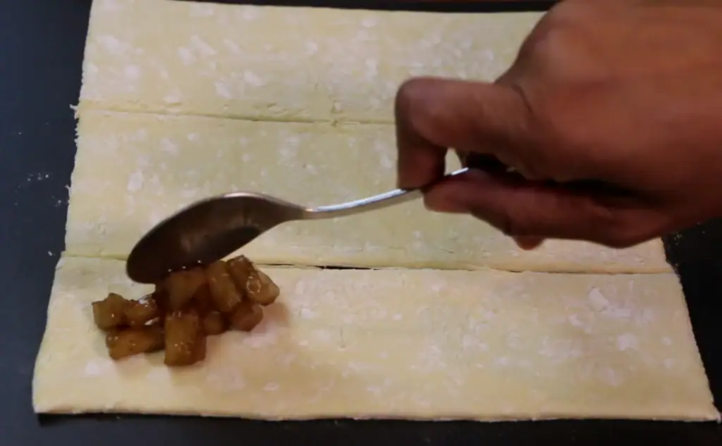 Adding the filling to Puff Pastry for Fried Apple Pie
