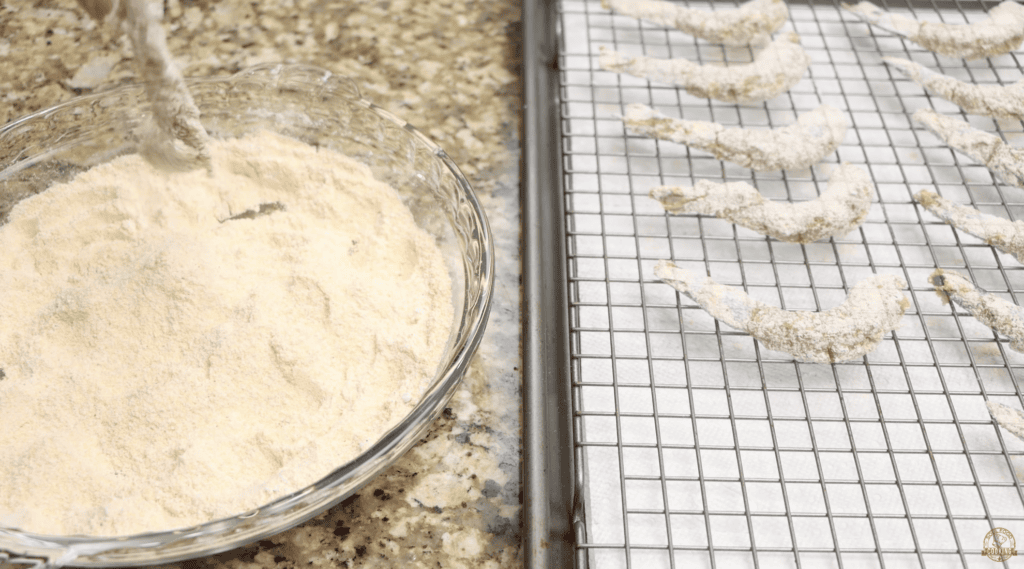 Dredging Shrimp in the Flour Cornmeal Mixture for Cajun Shrimp