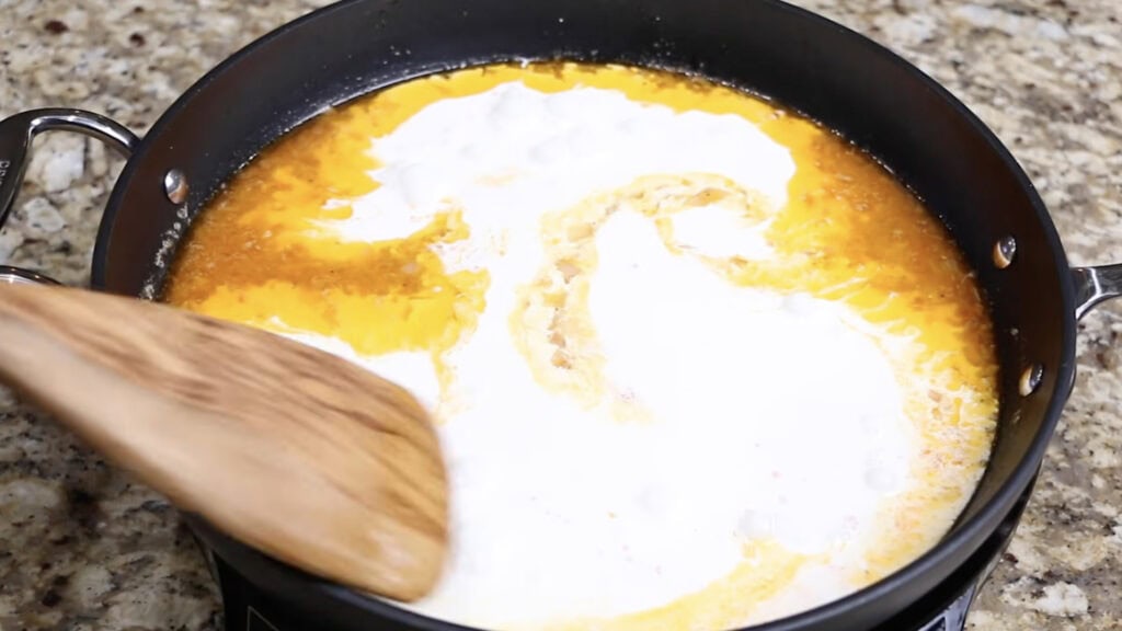 Adding the Heavy Cream to Make Alfredo Sauce