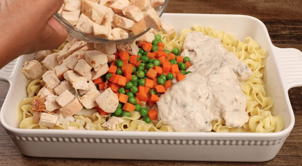 Adding the chicken to Chicken Noodle Casserole