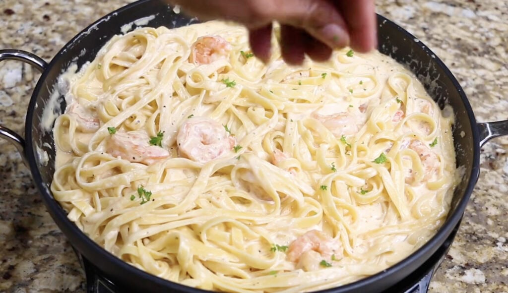 Shrimp Fettuccine Alfredo sprinkled with parsley