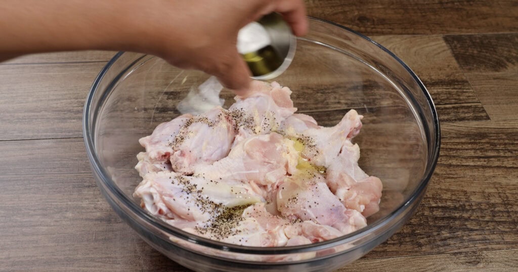 Adding Olive Oil to Wings in a Bowl