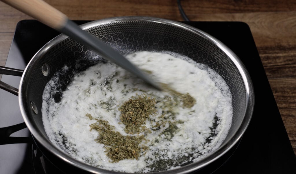 Adding the Parsley Flakes to the butter and garlic