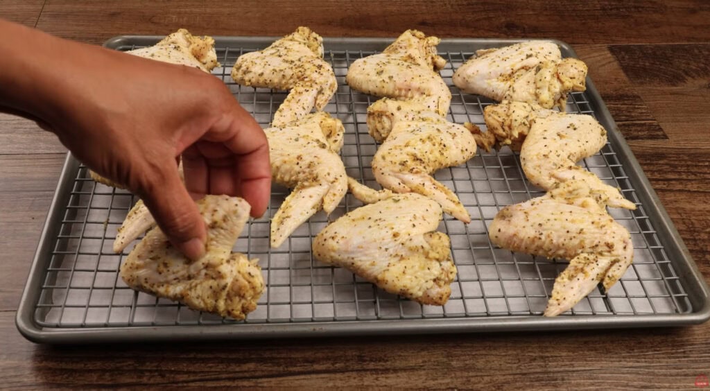 Placing Lemon Pepper Wings on a Wire Rack