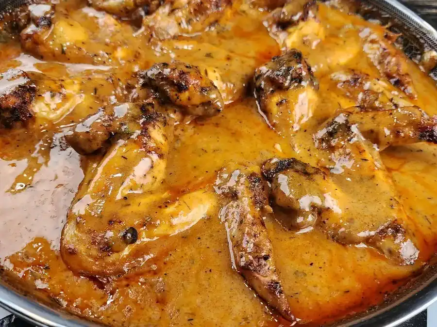 Smothered Chicken Wings in gravy in a skillet