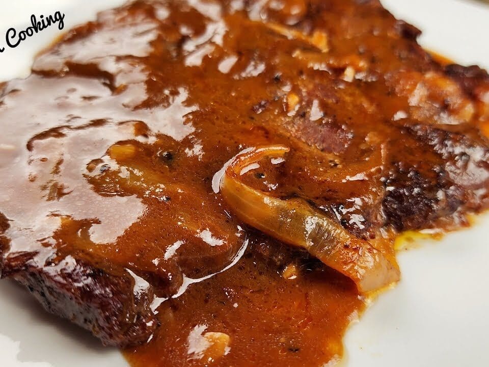 Smothered Steak and onion on a white plate