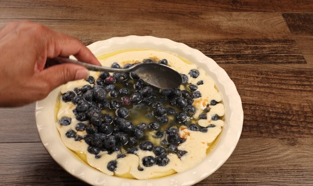 Adding the Blueberries to the Pie Dish for Blueberry Cobbler
